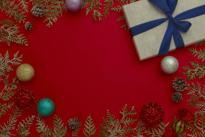 Directly above shot of christmas decorations on red background