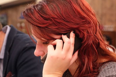 Close-up of young woman talking on mobile phone