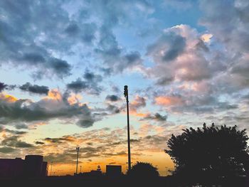 Low angle view of communications tower against sky during sunset