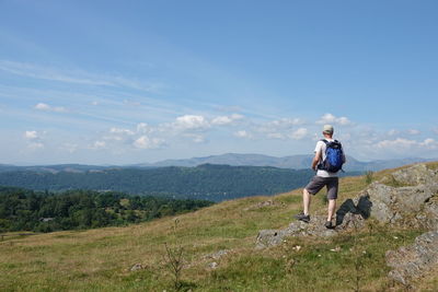 Man standing on land against sky