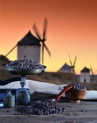 Close-up of fruits on table against sky during sunset