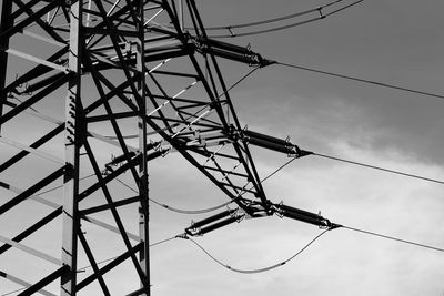 Low angle view of electricity pylon against sky