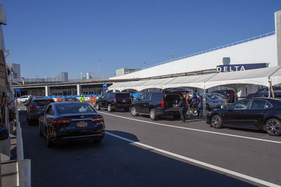 Vehicles on road against clear blue sky