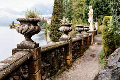 Statues on old temple against trees