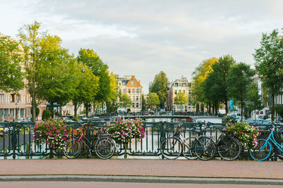 Bicycles parked by railing in city