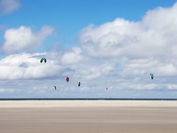 Scenic view of beach against blue sky