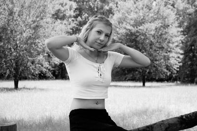 Portrait of young woman standing in park