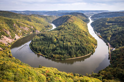 High angle view of river amidst trees against sky