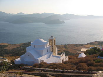 Scenic view of sea and mountains against sky