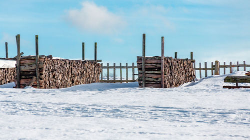 Built structure on snow against sky