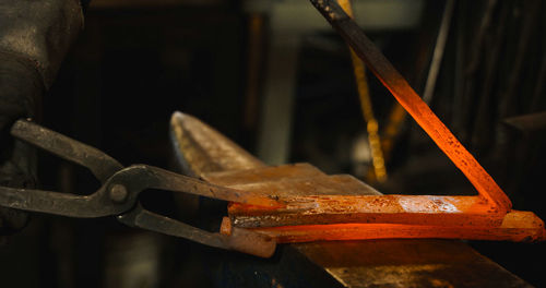 Cropped image of blacksmith working in workshop