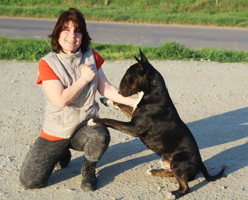 Young woman with her english bull terrier 