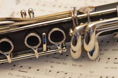 Close-up of flute on musical notes