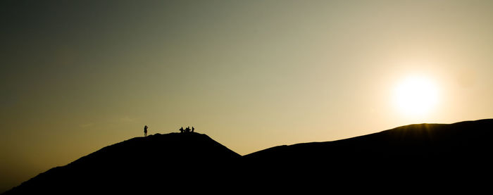 Panoramic shot of mountain against clear sky during sunset