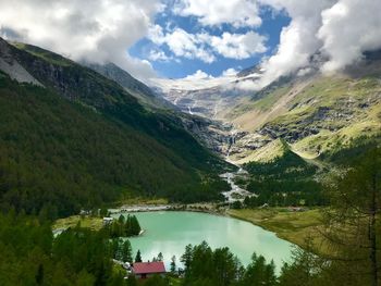 Scenic view of lake by mountains against sky