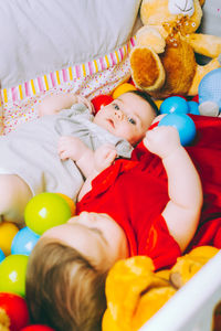 High angle view of cute baby lying on bed at home