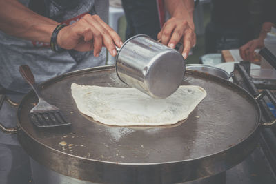 Midsection of man preparing food at market stall