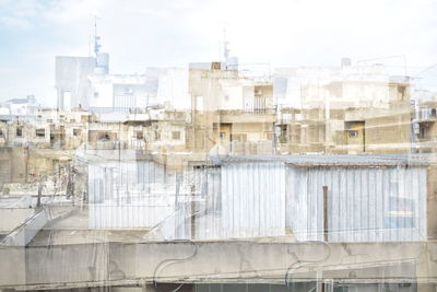 Buildings in city against clear sky