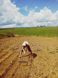 Man standing on field against sky