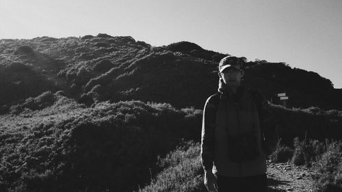 Man looking at mountain against sky