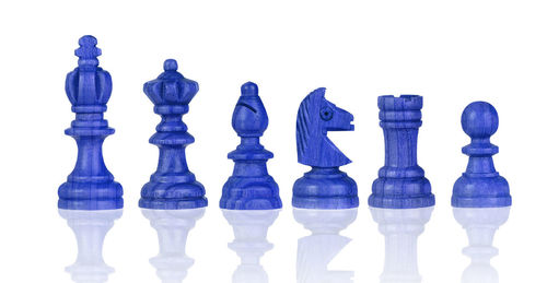 Close-up of chess pieces against white background