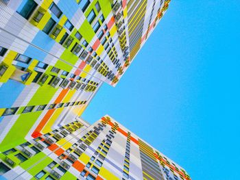 Low angle view of modern buildings against clear blue sky