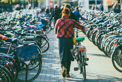 Rear view of man riding bicycle on road