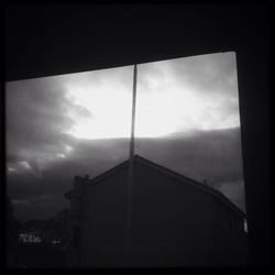 Low angle view of built structure against cloudy sky