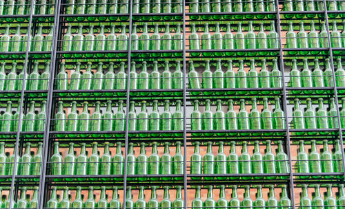 Full frame shot of wine bottles on rack