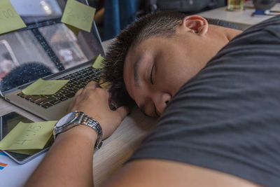 High angle view of man sleeping on bed