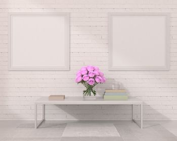 Flower vase on table against wall