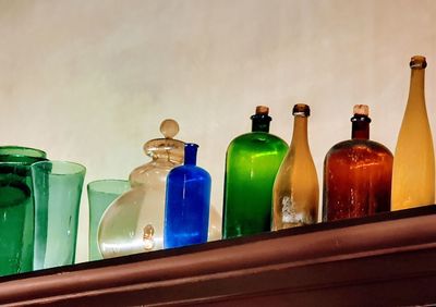 Close-up of multi colored bottles on table