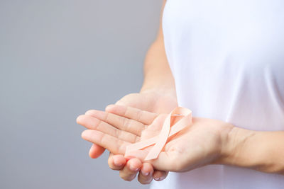 Midsection of man with nail polish