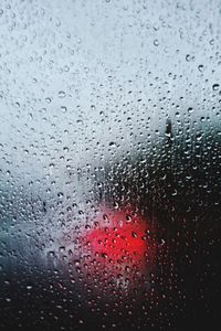 Full frame shot of raindrops on glass window