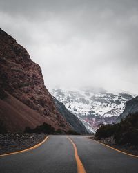 Road amidst mountains against sky