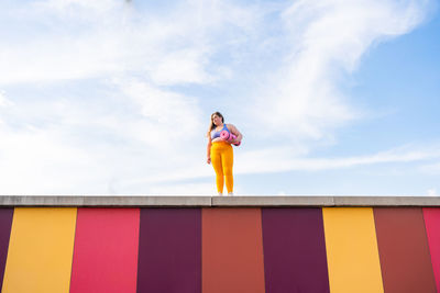 Low angle view of man standing against sky