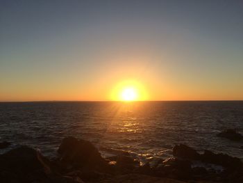 Scenic view of sea against clear sky during sunset