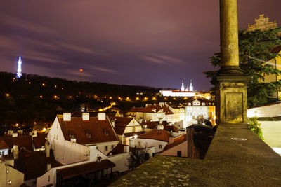 Illuminated cityscape against sky at night