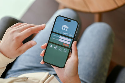 Midsection of man using mobile phone