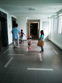 People walking in corridor of apartment