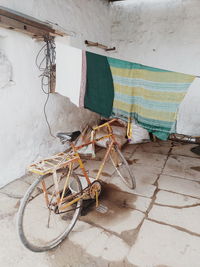 Abandoned shopping cart against wall in old building