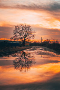 Scenic view of lake against orange sky