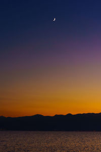 Scenic view of sea against clear sky at sunset