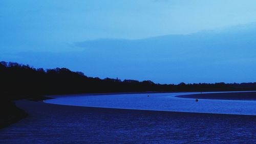 Scenic view of lake against sky at sunset