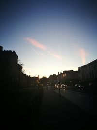 Silhouette buildings against sky at sunset