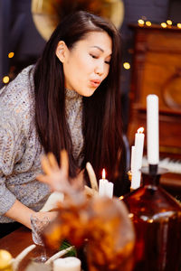 Woman blowing candle during christmas