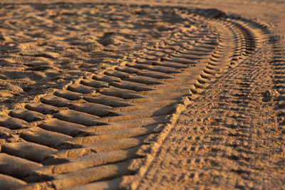 Full frame shot of tire tracks on sand