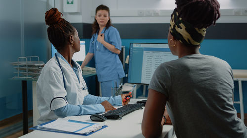 Doctor and nurse examining patient in clinic