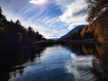 Scenic view of lake in forest against sky