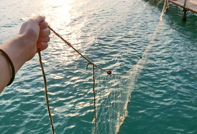 Close-up of man fishing in sea